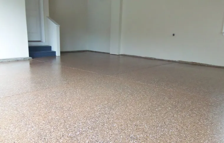 Tan and gray flake floor finished across a wide open room